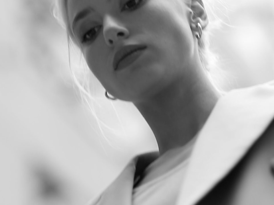 Frame from the Kinnon fashion film — a woman in monochrome