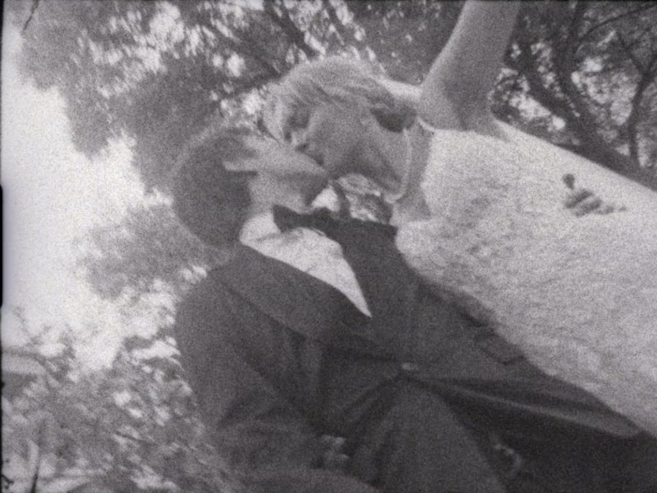 Frame from a Super 8 wedding film — a couple in black and white