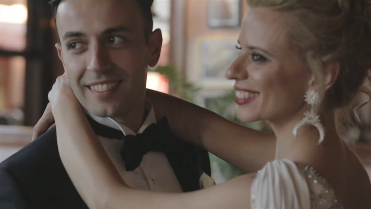 A bride and groom laughing together on the dance floor, from the wedding film George & Ekaterini